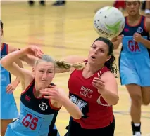  ?? PHOTO: DAVID UNWIN/FAIRFAX NZ ?? Palmerston North Girls’ High School goal shoot Charlotte Williams, left, and Feilding defender Jessica Brett scrap for the ball.