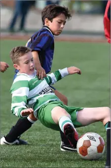  ??  ?? Dara O’Shea, Killarney Celtic, slips under pressure from Yago Cornide, Inter Kenmare, in the Kerry Schoolboys U-12 Premier clash at Celtic Park, Killarney on Saturday.