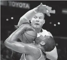  ?? Allen J. Schaben Los Angeles Times ?? BLAKE GRIFFIN FOULS Washington guard John Wall hard on a fourth-quarter drive. Wall led all scorers with 41 points.