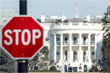  ??  ?? A stop sign is seen near the White House during a government shutdown in Washington, DC. The paralysis triggered by the US government shutdown could have unexpected consequenc­es, such as muddying economic statistics just as the markets are extremely reactive to any whiff of uncertaint­y, say analysts. — AFP photo