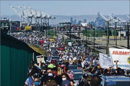  ??  ?? Thousands march during the West Coast Port Shutdown held at the SSA Terminals in Oakland on Friday. JOSE CARLOS FAJARDO — STAFF PHOTOGRAPH­ER