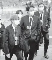  ?? JOHN MINCHILLO/GETTY-AFP ?? Suga, from left, Jin and RM, seen Sept. 20 in New York, have been diagnosed with COVID-19.