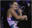  ?? DITA ALANGKARA — THE ASSOCIATED PRESS ?? Aryna Sabalenka of Belarus hugs the Daphne Akhurst Memorial Trophy after defeating Elena Rybakina of Kazakhstan in the women’s singles final at the Australian Open in Melbourne, Australia, on Saturday.