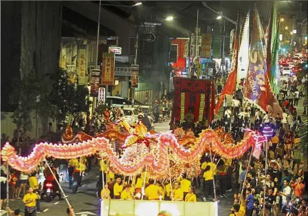  ??  ?? Captivatin­g sight: People filling the streets of George Town to witness the annual Penang Chingay, Lion and Dragon Dance Parade.