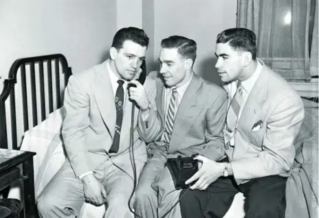 ?? NAT TUROFSKY/HHOF IMAGES ?? The old days are gone in which two — or in this case, three — teammates had to share one room on a road trip. Here, Montreal Canadiens teammates Bernie Geoffrion, on the telephone, Paul Meger, centre, and Dollard St. Laurent are pictured in a Royal...
