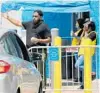  ?? STEPHEN M. DOWELL/ ORLANDO SENTINEL ?? Walmart employees wave customers away from the entrance at the Walmart store on S. John Young Parkway on June 23.