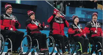  ?? JOEL MARKLUND/AFP/GETTY IMAGES ?? From the left, Canada’s Mark Ideson, Ina Forrest, Dennis Thiessen, Marie Wright and Jamie Anseeuw celebrate on Saturday after receiving their bronze medals following the wheelchair curling competitio­n at the Gangneung Curling Centre during the...