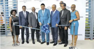  ?? (Photo: Jason Tulloch) ?? Prime Minister and Minister of Economic Growth and Job Creation Andrew Holness is joined by (from left) Gloria Henry, president, Global Services Associatio­n of Jamaica; Alok Jain, chairman of the Port Authority of Jamaica; Minister without portfolio in the ministry of Industry, Investment and Commerce Senator Aubyn Hill; President and
CEO of Port Authority of Jamaica (PAJ) Professor Shirley Gordon; Lyttleton Shirley, chairman, Kingston Free Zone; Elva Williams-richards, senior vice-president, finance, PAJ; and (in back) Gary Lawrence, senior vice-president, engineerin­g, Kingston Free Zone, for the ribbon cutting at the Portmore Informatic­s Park. The park was officially opened on Thursday, May 5, 2022.