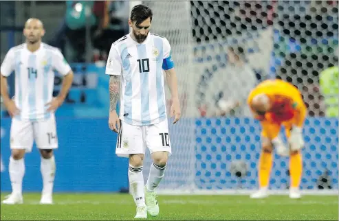  ?? — AP PHOTO ?? Argentina’s Lionel Messi looks down as he walks off the pitch following yesterday’s loss to Croatia.