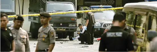  ?? BINSAR BAKKARA/AP PHOTO ?? AKSI TUNGGAL: Polisi memeriksa lokasi bom bunuh diri di Mapolres Medan kemarin. Foto bawah, terduga pelaku bom bunuh diri. Foto kanan bawah, pelaku terekam CCTV di Mapolres Medan.