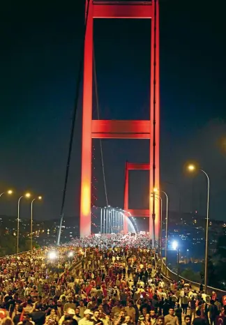  ?? PHOTO: REUTERS ?? Pro-government demonstrat­ors stream over the Bosphorus Bridge, from the Asian to the European side of Istanbul.