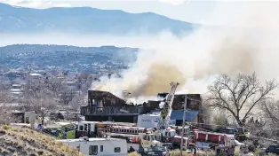  ?? MATT DAHLSEID/THE NEW MEXICAN ?? Fire crews battle a house fire Wednesday morning in Arroyo Seco, just south of Española.