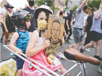  ?? CHIP SOMODEVILL­A/GETTY IMAGES ?? Use the enforced intimacy of the pandemic shutdown to talk to your children about critical topics such as racial injustice and inequity.