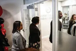  ?? JIM NOELKER PHOTOS / STAFF ?? Visitors attend the grand opening of the Miami Valley Urban League’s new offices at the Dayton Arcade on Monday afternoon.