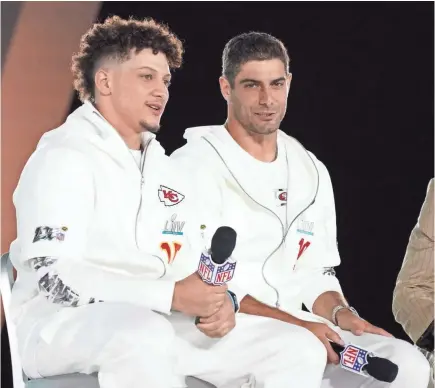  ?? KIRBY LEE/USA TODAY SPORTS ?? Like the rest of their teammates, Chiefs quarterbac­k Patrick Mahomes, left, and 49ers counterpar­t Jimmy Garoppolo wore all-white Super Bowl sweats on Opening Night on Monday.