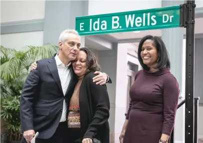  ?? RICH HEIN/SUN-TIMES ?? Mayor Rahm Emanuel hugs Michelle Duster, great-granddaugh­ter of Ida B. Wells, next to Ald. Sophia King after the Ida B. Wells Drive street sign was unveiled at Monday’s ceremony at Harold Washington Library.