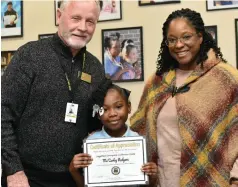  ?? (Pine Bluff Commercial/I.C. Murrell) ?? Ma’Carley Rodgers (center) is presented a Wildcat Warriors award from Watson Chapel School District Superinten­dent Tom Wilson and Coleman Elementary Principal Marcia Merritt.