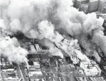  ?? CY WOLF/CHICAGO TRIBUNE ?? An aerial view of the West Side shows smoke rising from several fires ignited by rioters along West Madison and Leavitt streets, west to Spaulding Avenue, on April 5, 1968.