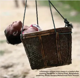  ?? Photo: Reuters/Mohammad Ponir Hossain ?? A Rohingya refugee child sleeps in a basket after crossing the border in Palong Khali, Bangladesh, yesterday.