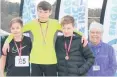  ??  ?? Top boys S1 boys winner Robb Ferguson (Lornshill) with runner-up Ethan Duncan (Alva), third-placed Jake Foley (Lornshill) and Ronnie O’Grady (Scottish Athletics)