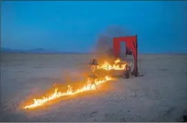  ?? Allen J. Schaben ?? A FIERY TABLEAU in the Mojave Desert, part of a Maná music video, makes an apropos image for the band’s new album, “Cama Incendiada” (Burning Bed).