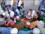  ?? (AP/Jossy Ola) ?? Babagana Umara Zulum (center) governor of Borno state, prays Sunday during a funeral for those killed by suspected Boko Haram militants in Zaabarmar, Nigeria.