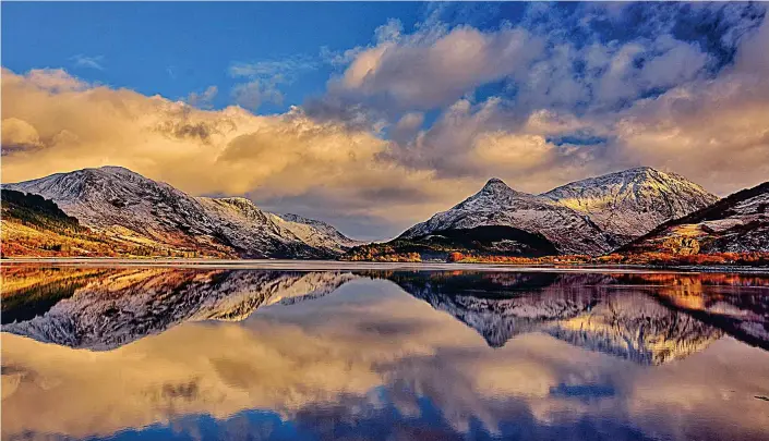  ??  ?? Breathtaki­ng: Snow-covered peaks around Glencoe are reflected in all their majesty in the waters of Loch Leven on one of the coldest days of the year yesterday