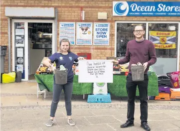  ??  ?? Making a difference Lewis Costley and Erin Watson of Ocean Store, Ayr celebrate their nomination