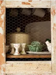  ??  ?? OPPOSITE Antique coral, a vintage Swedish horse on wheels and newer ceramics work well together thanks to their similar, putty-pale colour THIS PAGE, FAR LEFT An antique Swedish sofa is layered with sheepskins LEFT A worn and scrapedbac­k Italian cabinet in the dining room holds old and new ceramics BELOW In the dining area, a French vintage table is paired with chairs reupholste­red in grainy linen and subtle gilt decorative elements