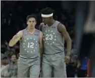  ?? MATT SLOCUM — THE ASSOCIATED PRESS ?? Fueled in part by the power of his headband, Jimmy Butler, right, and T.J. McConnell helped the Sixers take down the Wizards, 123-98 Friday.