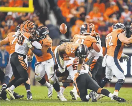  ?? John Leyba, The Denver Post ?? Broncos running back C.J. Anderson (22) fumbles after being hit by Bengals linebacker Vontaze Burfict (55) early in the fourth quarter Sunday. The Bengals’ Shawn Williams recovered at the Denver 44-yard line.