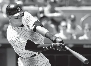  ?? Associated Press ?? New York Yankees' Aaron Judge hits a double during the fourth inning of a baseball game Sunday against the Baltimore Orioles in New York.