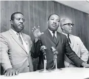  ?? AP/FILE ?? Martin Luther King Jr. stands with Miami attorney Henry Arington upon arriving in the city on June 26, 1965, to attend the World Baptist Congress.