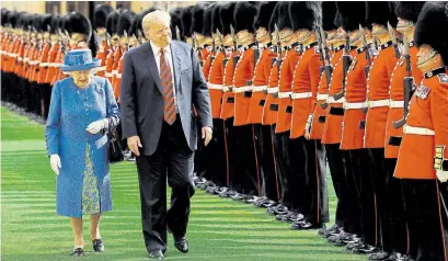  ?? AGENCE FRANCE-PRESSE ?? Queen Elizabeth and U.S. President Donald Trump inspect the guard of honour during a ceremony at Windsor Castle Friday.