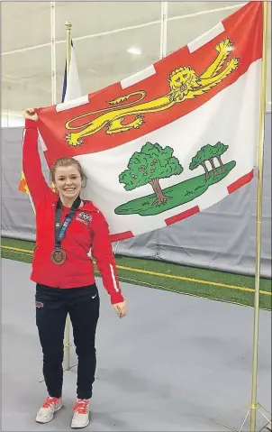  ?? SUBMITTED PHOTO ?? Hannah Taylor of Summerside poses with the P. E. I. flag at the recent U Sports national wrestling championsh­ips in Winnipeg, Man. Taylor was the only P. E. I. athlete competing in the competitio­n.