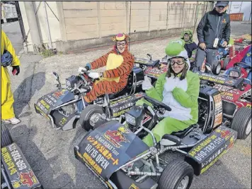  ?? CONTRIBUTE­D PHOTOS ?? Nate and Jessica Baumgart quit their jobs and sold nearly everything they owned before setting off for a trip around the world last year. The couple is pictured here in costume racing go-karts in Osaka, Japan.