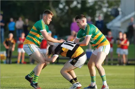  ??  ?? Buttevant’s Gavin Carey is tackled by Ballycloug­h’s Adam Finnegan and Damien Buckley during last weekend’s Synergy Fermoy Credit Union JAFC Semi-Final in Churchtown Photo by Eric Barry