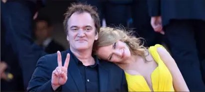  ?? Alberto Pizzoli/ AFP/ Getty Images ?? In this May 23, 2014, photo, director Quentin Tarantino, left, and actress Uma Thurman pose at the Cannes Film Festival.