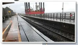  ??  ?? With the ‘Wavewalker’ in the background, the Up line at Dawlish is covered with seawater on February 2.