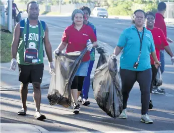  ?? Photo: Waisea Nasokia ?? Luisa Tigarea (front, right) leads her team during the clean-up campaign in Namaka on May 5, 2018.