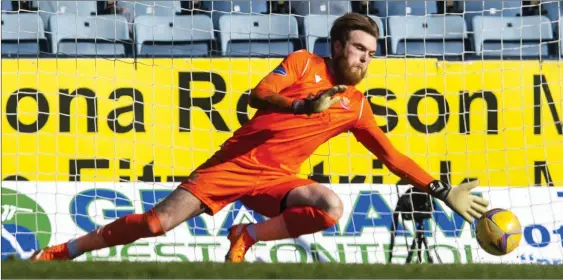  ??  ?? St Johnstone goalkeeper Zander Clark saves the penalty from Charlie Adam that he had just given away for a foul on Danny Mullen