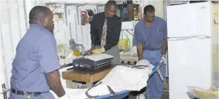  ??  ?? A police investigat­or looks on as undertaker­s remove the body of a murder victim from his home in this 2004 file photo. The chance of the violent act failing has very little to do with the standard of law enforcemen­t and its control over its environmen­t.