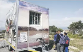  ??  ?? HUMBLING. Pupils shown a replica of Nelson Mandela’s Robben Island Prison Cell in Mitchells Plain, Cape Town, yesterday.