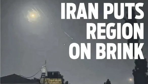  ?? ?? A video grab shows explosions lighting up the Jerusalem sky during an Iranian attack on Israel. Below left: Israel Prime Minister Benjamin Netanyahu (centre) during a war cabinet meeting at the Kirya in Tel Aviv. Below right: Demonstrat­ors wave Iran’s flag and Palestinia­n flags as they gather in front of the British Embassy in Tehran. Pictures: AFPTV / AFP