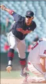  ?? AFP ?? Francisco Lindor of the Cleveland Indians tracks his throw to first base to complete a double play and end the sixth inning after forcing out Mike Trout of the Los Angeles Angels on Thursday at Angel Stadium in Anaheim, California.