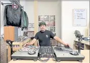  ??  ?? The Stacks Records owner Gabriel De La Cruz, who is also a DJ, poses by turntables at his store in Hayward.