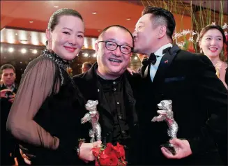  ?? EKATERINA CHESNOKOVA / SPUTNIK ?? Actress Yong Mei (left) and actor Wang Jingchun (right) celebrate with director Wang Xiaoshuai after they won Silver Bears for best actress and best actor at the 69th Berlin Internatio­nal Film Festival on Saturday.