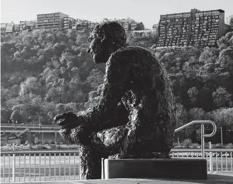  ?? Gene J. Puskar / Associated Press ?? A statue of Fred Rogers sits at the confluence of the Allegheny, Monongahel­a and Ohio rivers on the north side of Pittsburgh.