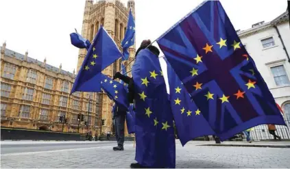  ?? - Reuters file photo ?? PROTEST: Anti-Brexit protesters wave EU and Union flags outside the Houses of Parliament in London, Britain.
