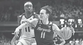  ?? ROBERT GODDIN/USA TODAY SPORTS ?? Marquette guard Tyler Kolek of Cumberland goes to the basket against Butler guard Jahmyl Telfort on Tuesday in Indianapol­is.